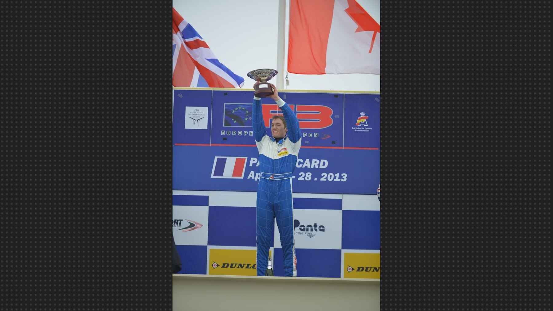 Nelson Mason on the winning podium with the Canadian flag above him